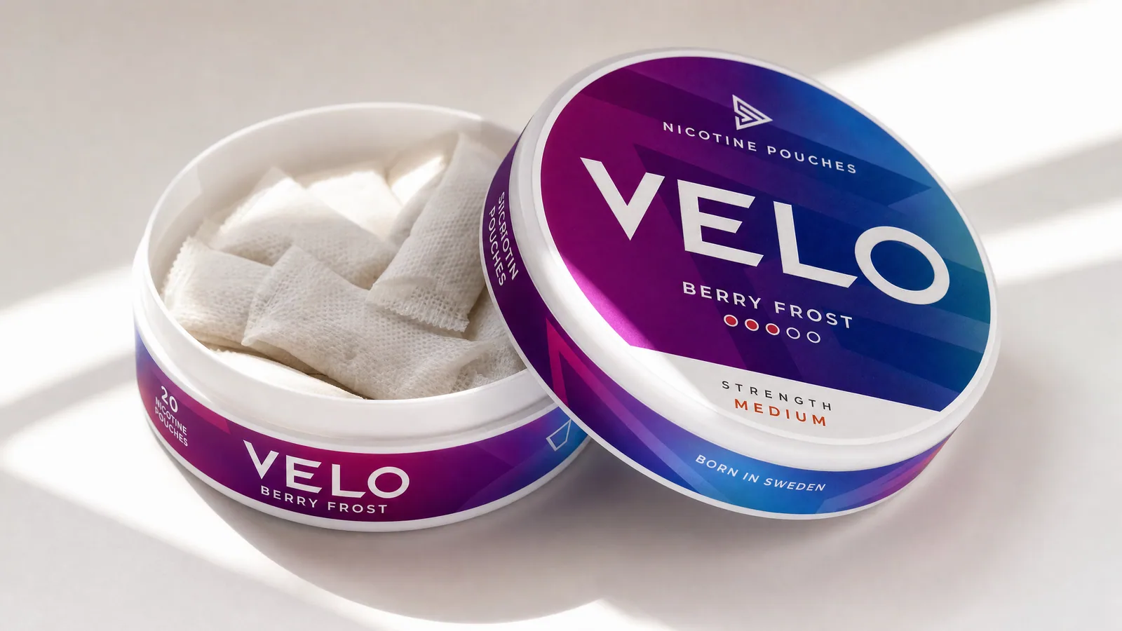A nicotine pouch package on a white surface, partially open, with a modern and colorful design.