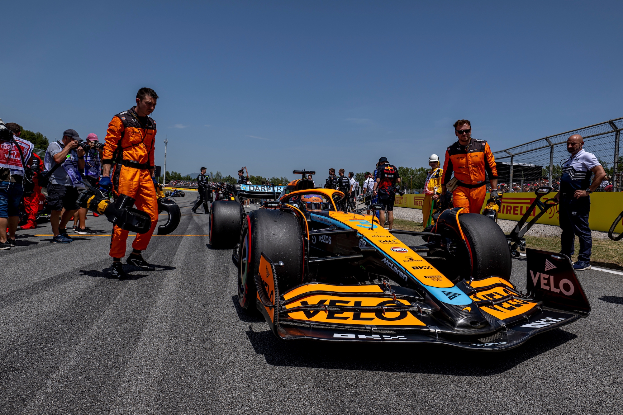 McLaren F1 car with Velo branding on the track during a race.