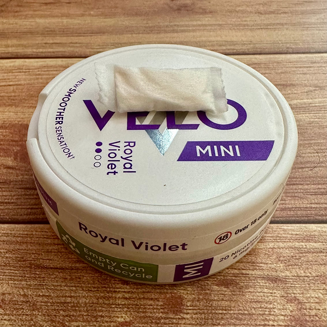 Velo Royal Violet / Purple Grape nicotine pouch can with mini pouch on top.