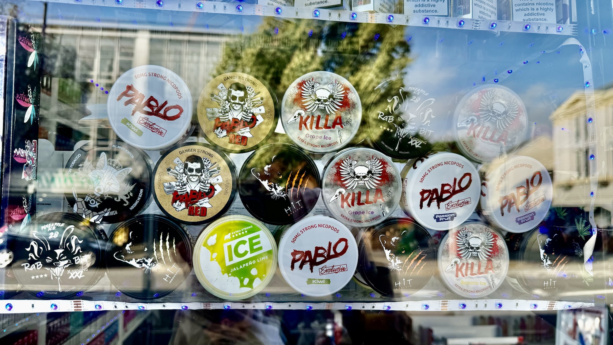 Nicotine pouches on display in a shop window - including Killa and Pablo.